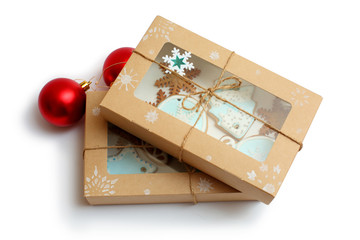 ginger cookies with blue frosting in a box on white background