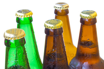 Necks of bottles with lids. Water droplets on  glass