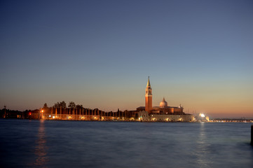 Fototapeta na wymiar sunset, night view from the sea on illuminated Venice, Italy. 
