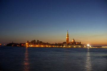 sunset, night view from the sea on illuminated Venice, Italy. 