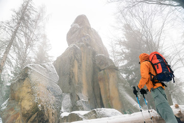 man looking at rock, wild place in the mountains, rock covered w