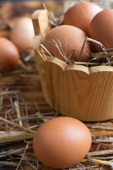 Brown eggs in the straw close-up in a rustic style