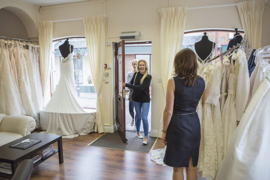 Female customers enter bridal shop