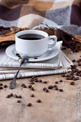 A cup of coffee Black coffee hot drink Grains Newspapers Wooden background Checkered Plaid Heart Fall