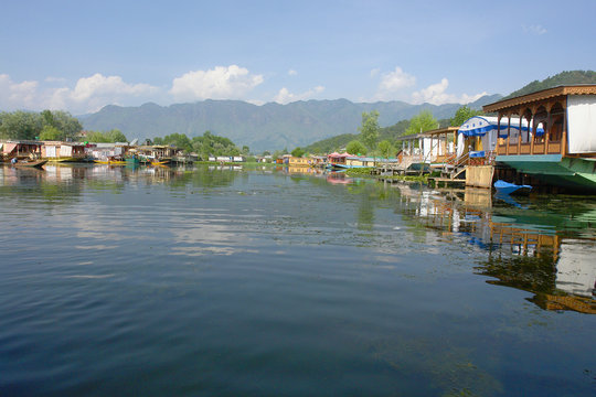 Lake Dal in Srinagar in Kashmir with  houseboats and  shikaras for ferrying guests to the shore
