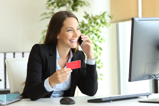 Businesswoman buying online and calling customer service