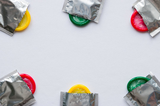 colored condoms on a white background. frame for text