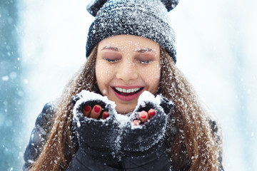 Winter young woman portrait. Beauty Joyful Model Girl laughing and having fun in winter park....