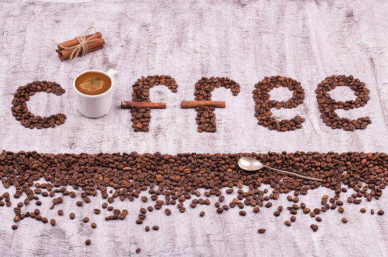 Fototapeta Coffee. An inscription from coffee grains. Letters from coffee grains. Coffee grains in the form of letters on a concrete background