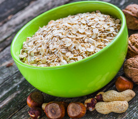 Oatmeal or oat flakes on dark wooden table