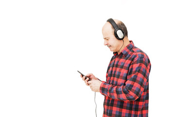 Man with headphones selects music in your phone. Listen to play list