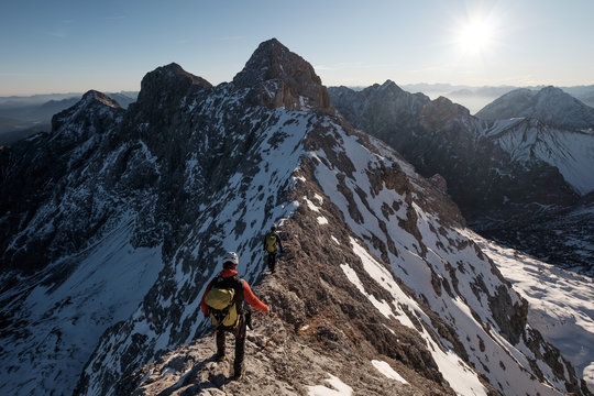 Mountaineer hiking on mountain peak in European Alps