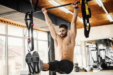 Muscular fitness instructor working out at the gym.