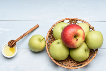 Apples, honey and wicker basket