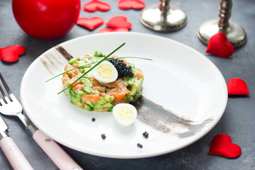 Salmon tartare with avocado black caviar and quail egg