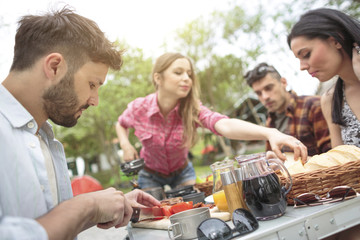 Group of friends eating at campsite