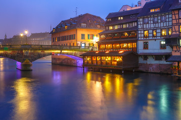 Traditional Alsatian half-timbered housesand bridge in Petite France during twilight blue hour, Strasbourg, Alsace, France