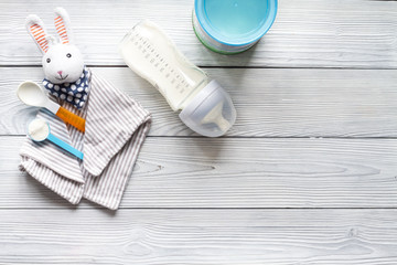 preparation of mixture baby feeding on wooden background top view