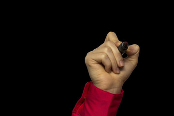 Fototapeta premium Hand holding marker isolated on black