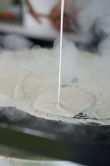 More Crepe Batter Poured on to Hot Griddle