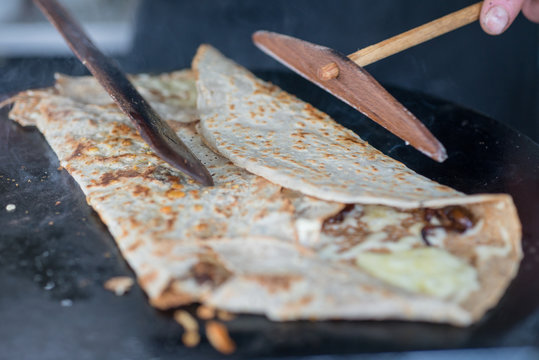 Cooking Crepe on Skillet Being Folded