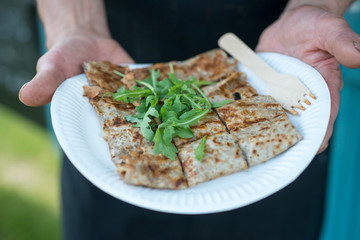 Hands Holding Crepe in Paper Plate