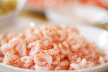 White bowl of fresly boiled shimps on the table