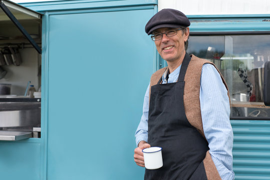 Man Standing Beside a Food Truck