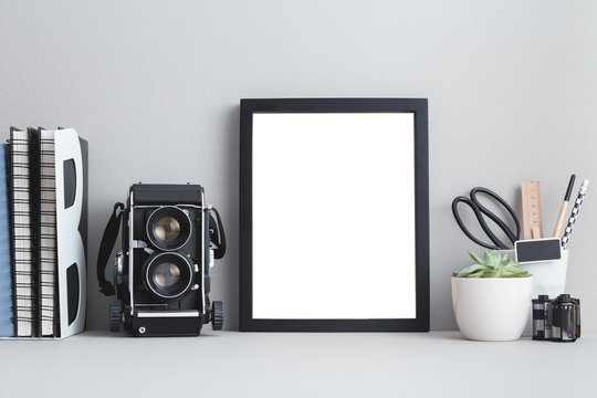 Photo Frame And A Camera On A Shelf.