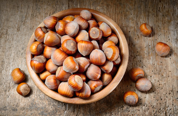 Hazelnut. Fresh organic filbert in plate on wooden background. N