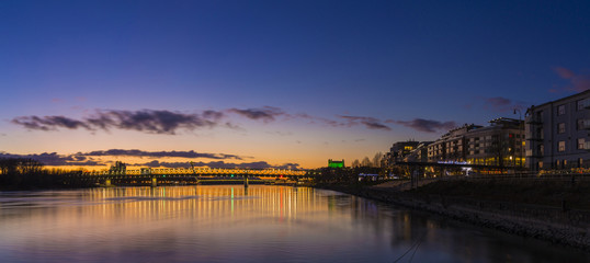 Fototapeta premium View from harbour at sunset, Bratislava castle, business buildin
