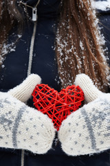 Rattan red heart in hands