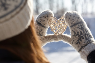 Woman holding hands in a heart shape