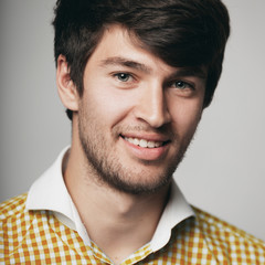 Fototapeta premium a large portrait of a happy young man in a plaid shirt