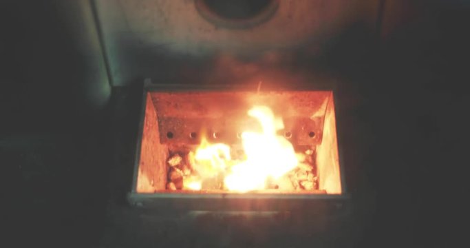 Video of a pellet stove with the wood pellets just starting to burn.