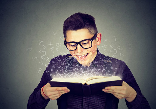 man reading a book with alphabet letters coming out
