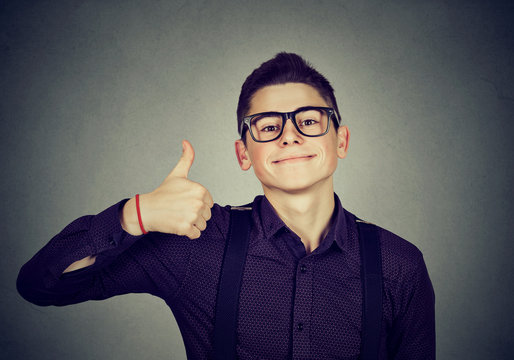 Successful teenager. Nerdy man giving thumbs up hand gesture sign