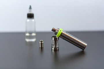 Parts of e-cigarette and a jar with fluid for personal vaporisers. Electronic nicotine delivery...