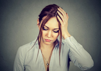 sad desperate woman with worried stressed face expression looking down