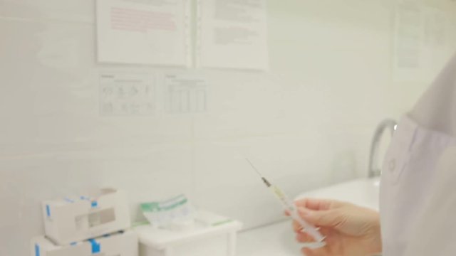 Man flicks syringe prior to drug injection,