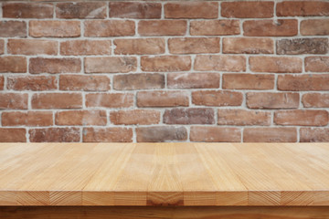 Wooden table with brick wall.