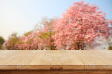 Naklejka na ściany i meble Empty wooden table and blurred bokeh background.