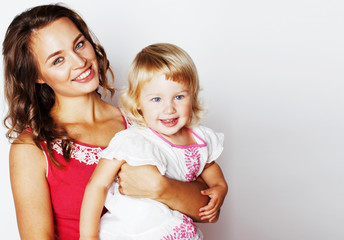 young pretty stylish mother with little cute daughter hugging, h