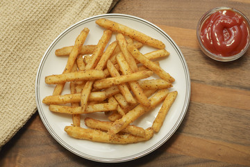 Fresh french fries on a wood background