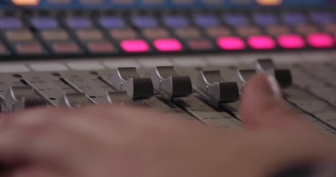 Mixing Board. Sweeping across the master controls of a professional sound mixing board.