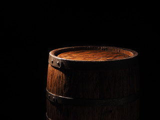Old barrel with cognac on wooden backgroun