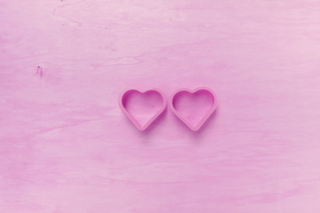 Abstract hearts on wood background with pink filter effect