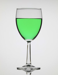Beautiful and elegant wine glass with green alcoholic beverage