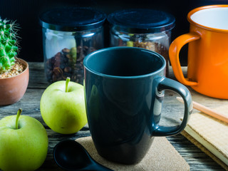 Coffee and apple on the table. During breaks eat fruit and a coffee is a good thing.