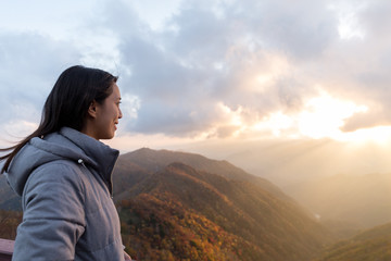 Woman looking at sunset on mountain